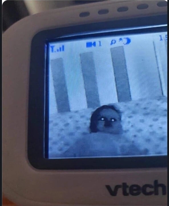 Korean community post, image 2: The monitor feed: a toddler staring back like something possessed.